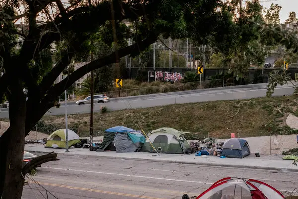 A homeless encampment lined each side of Glendale Boulevard, adjacent to a highway overpass in the Echo Park neighborhood of Los Angeles.